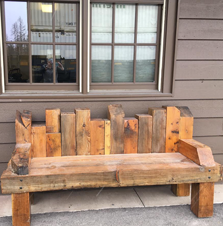 A one-of-a-kind wood bench built from various wood posts that held up Sperry Chalet during its winter stabilization in 2017-2018